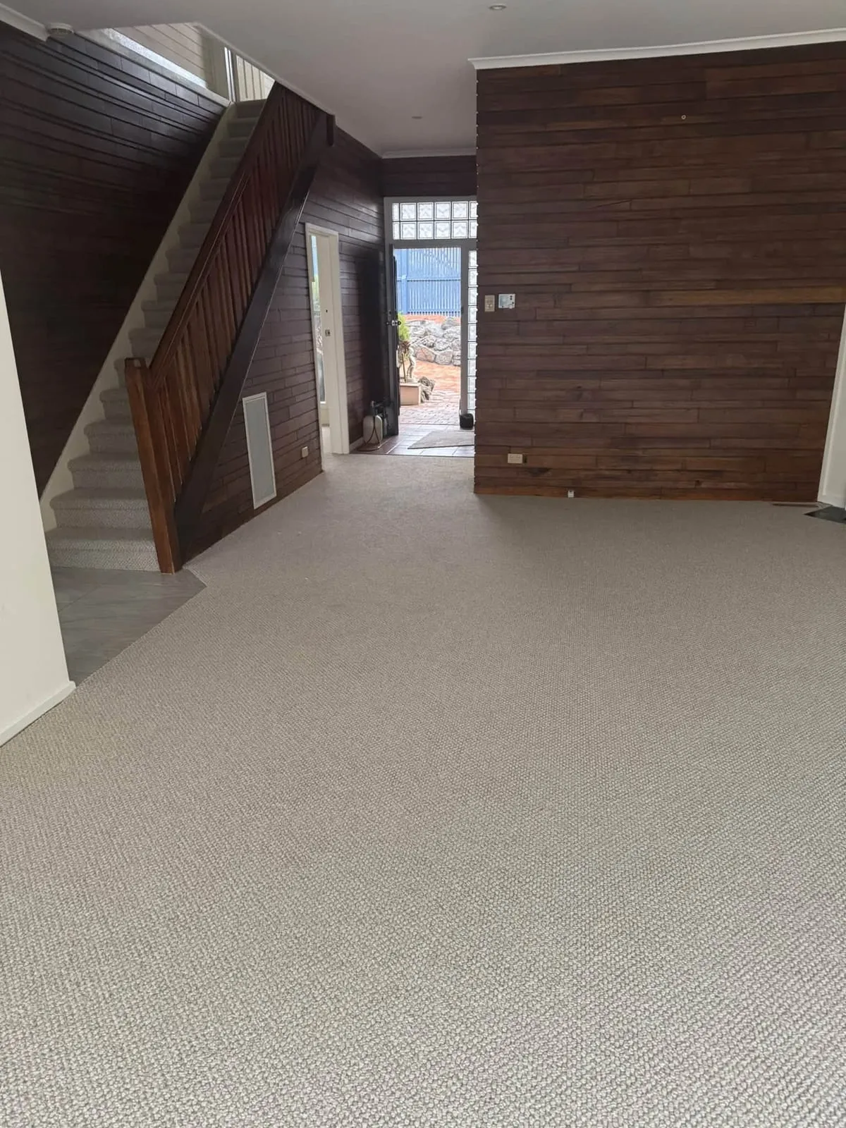 New carpet through a living area and up the staircase