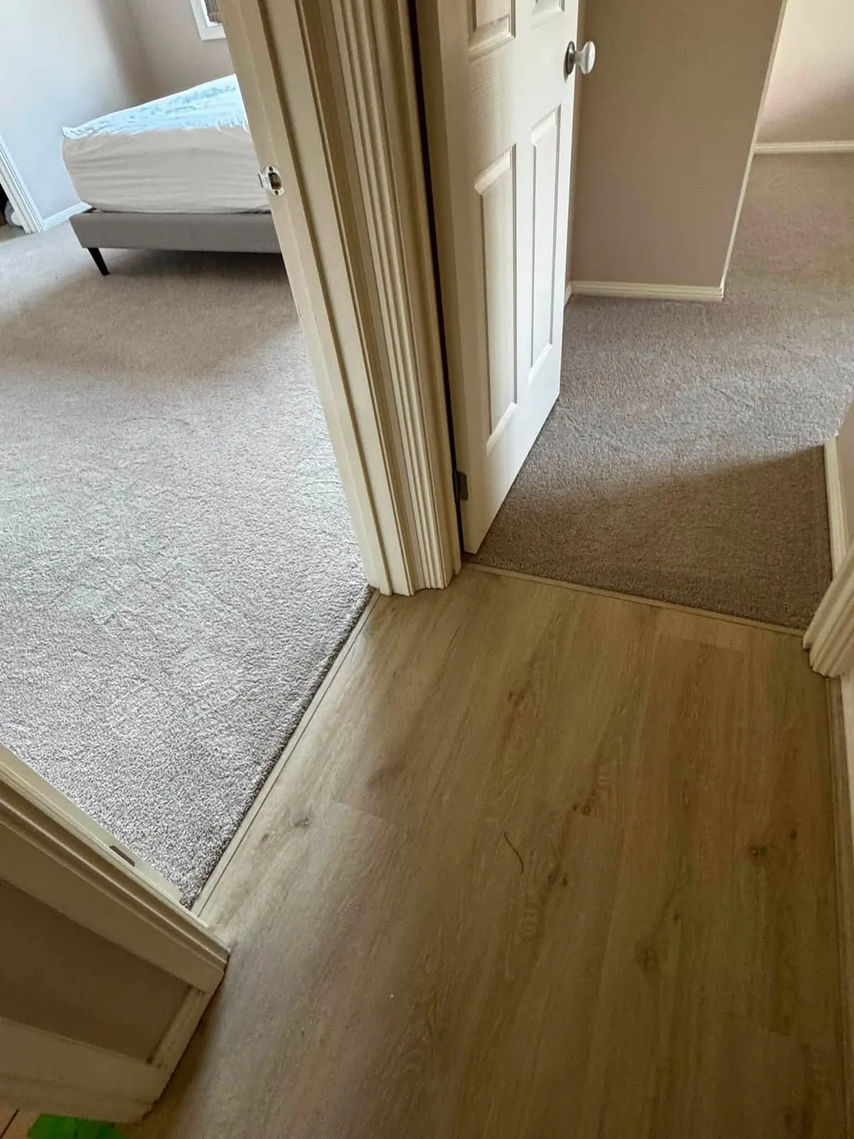 New carpet in a bedroom meeting hybrid flooring in the hallway, Pakenham