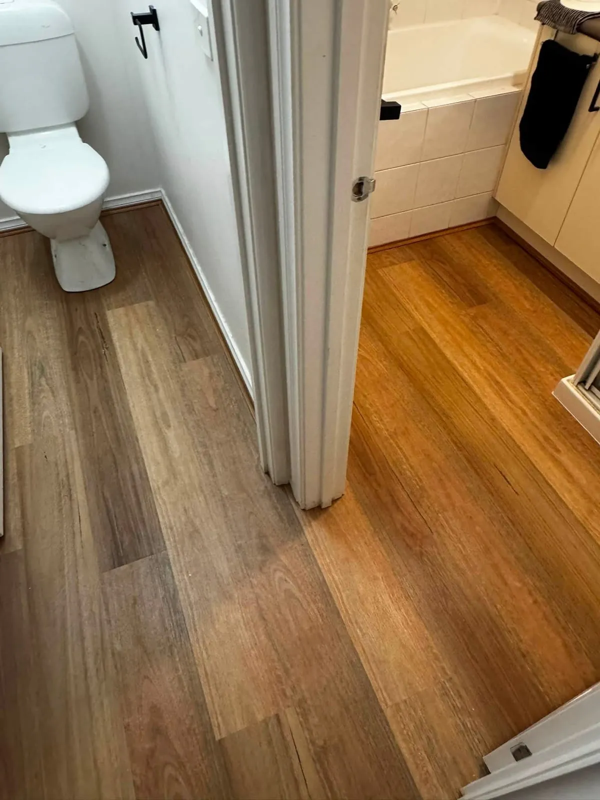 Hybrid flooring through a hallway past the bathroom, Langwarrin