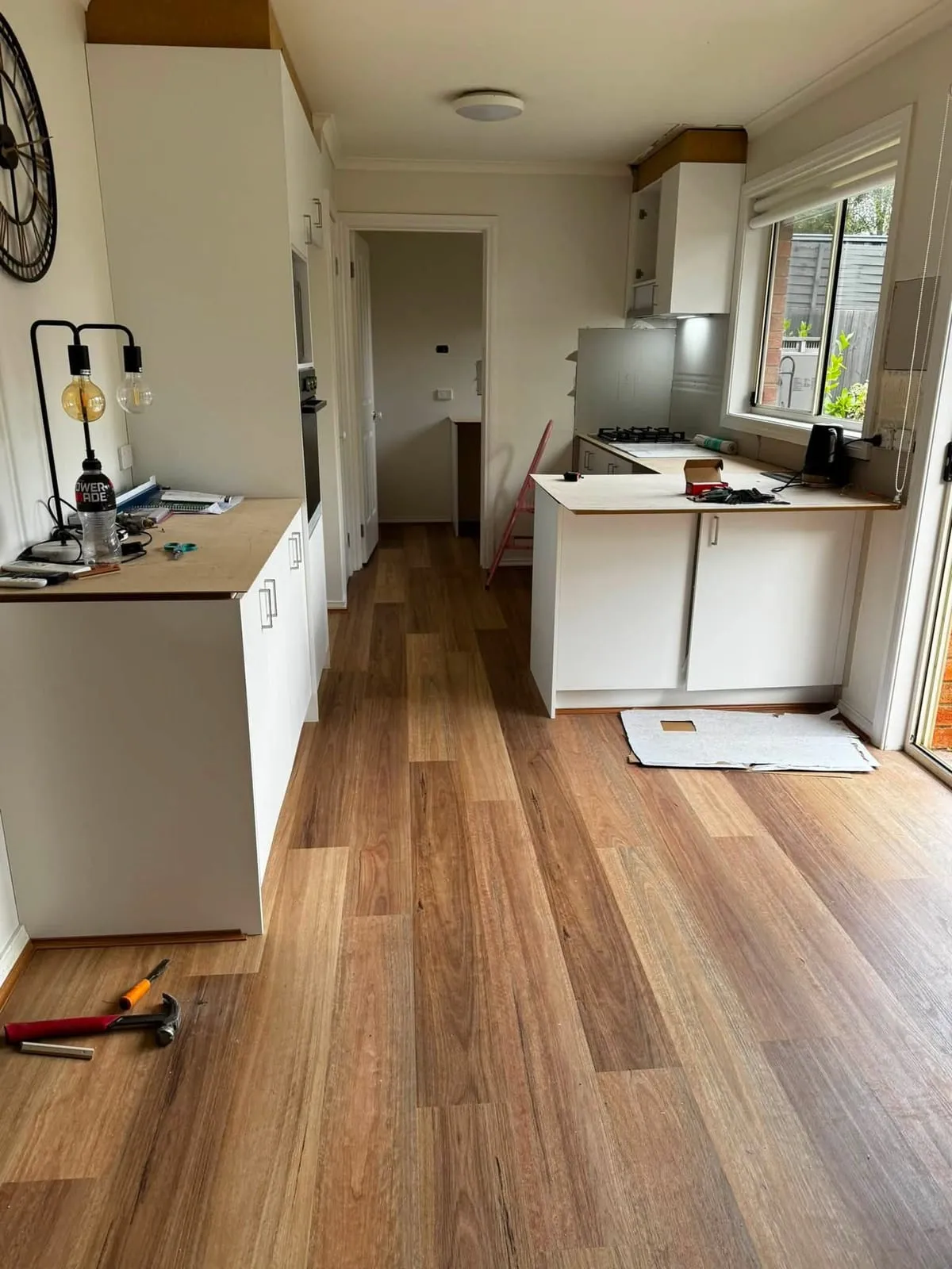 Timber-look hybrid flooring through a kitchen and dining area, Langwarrin